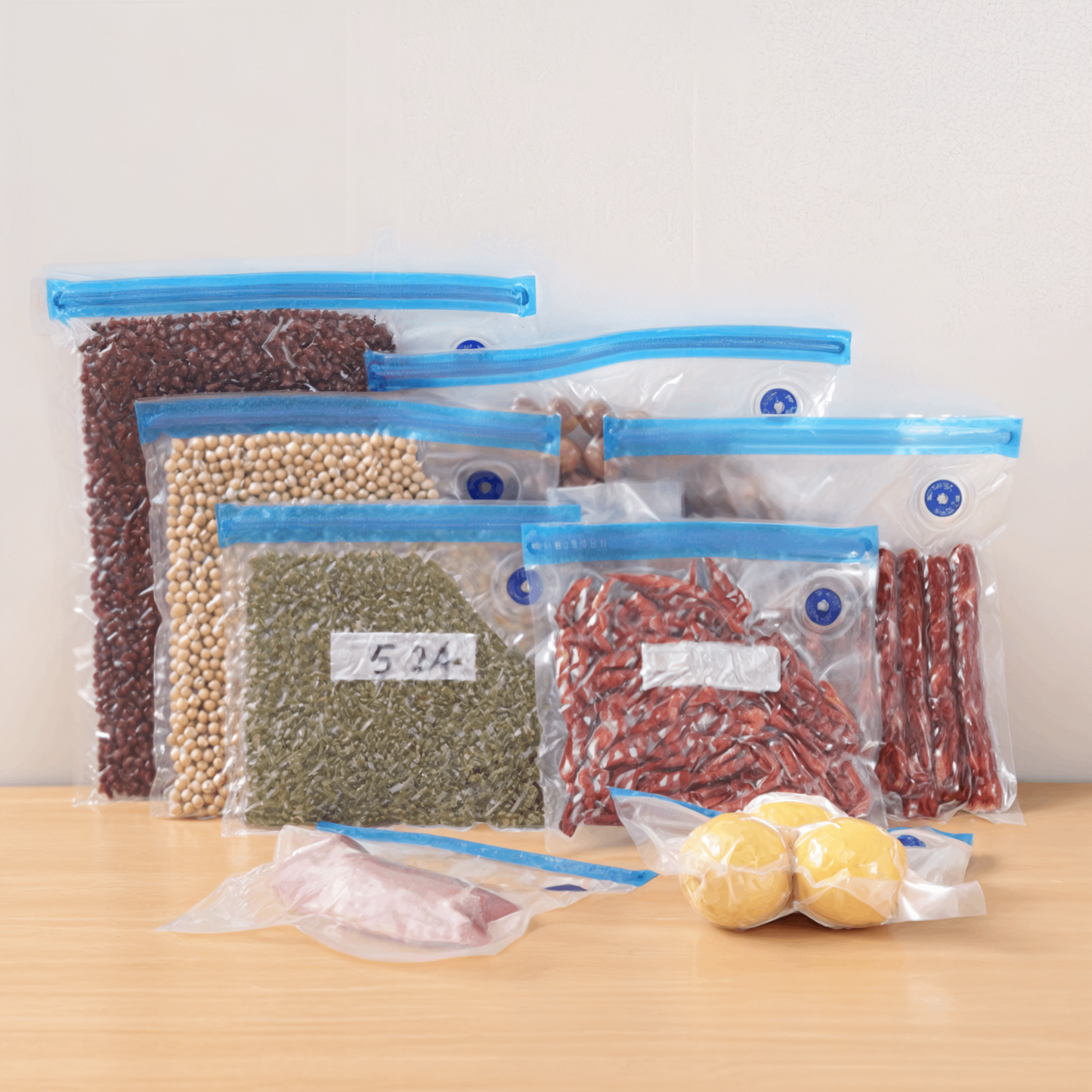 Reusable vacuum seal bags filled with beans, grains, spices, and lemons, neatly stored to keep food fresh longer.